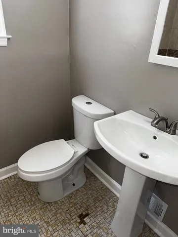 a white toilet sitting next to a bathroom sink