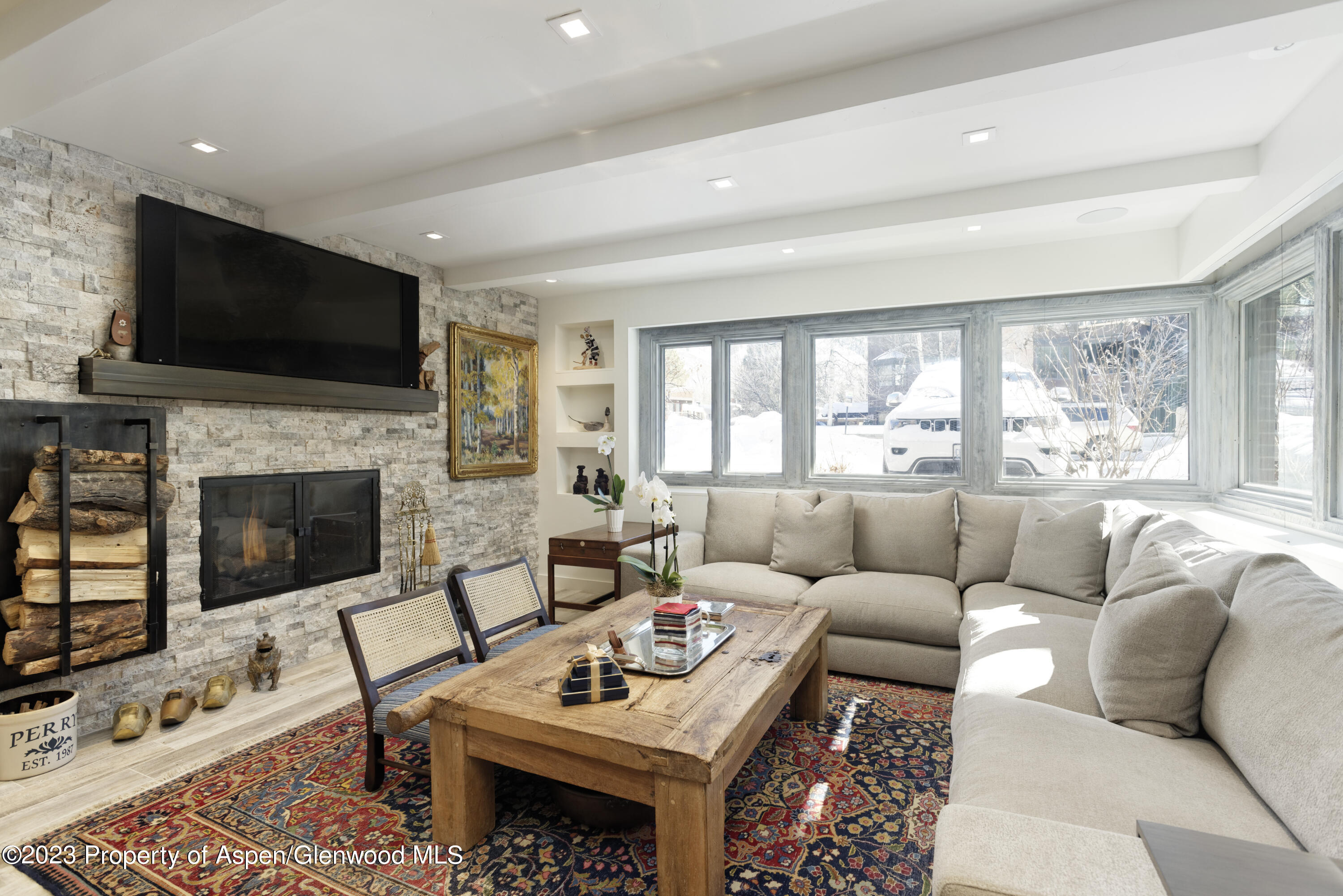a living room with furniture a flat screen tv and a fireplace