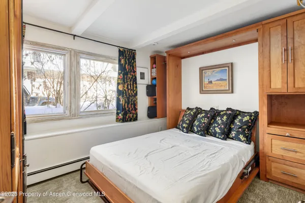 a bedroom with a large bed and a window