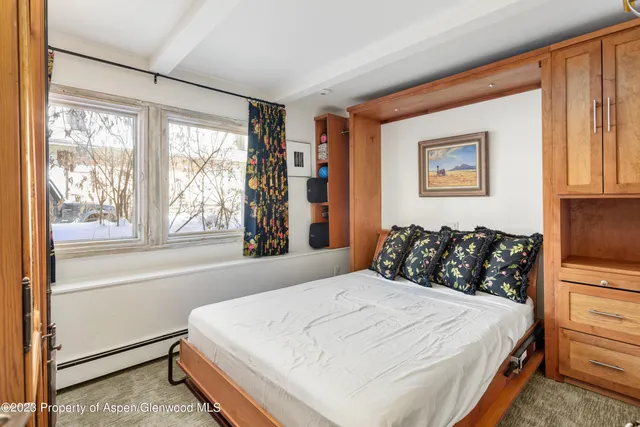 a bedroom with a large bed and a window