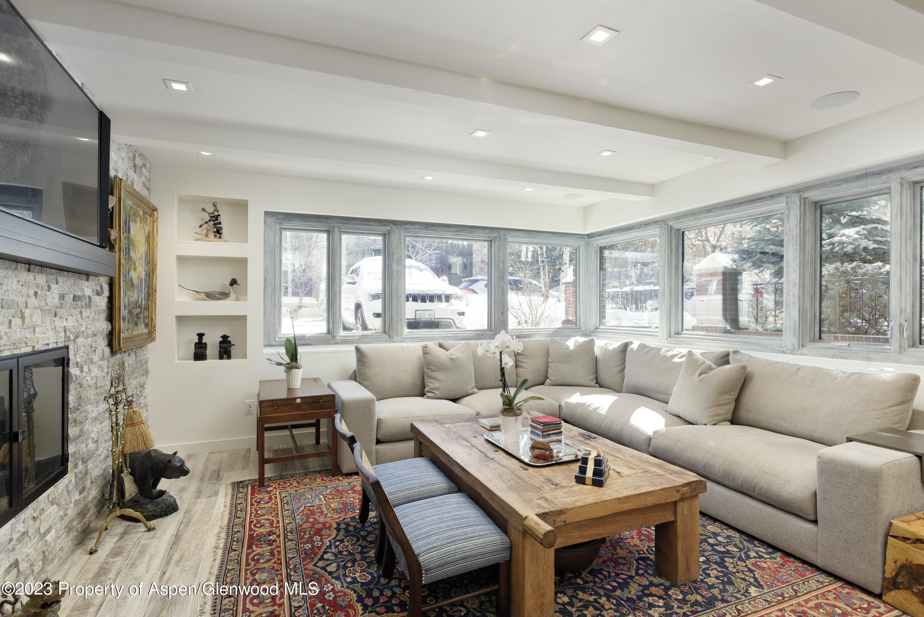 525 South Original Street, Unit B Aspen, CO 81611 - Photo 2 of 17 a living room with furniture a fireplace and a table
