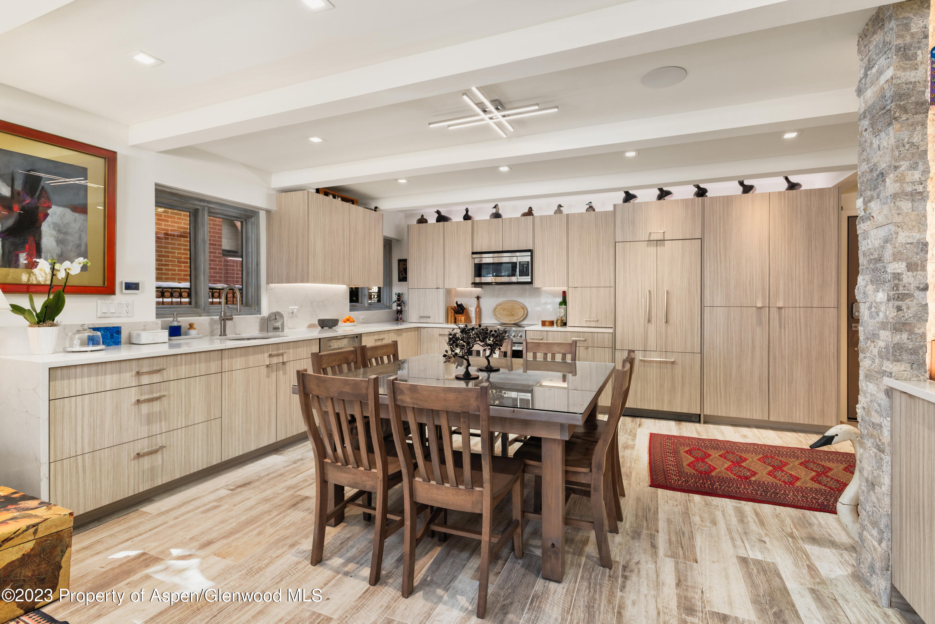 525 South Original Street, Unit B Aspen, CO 81611 - Photo 4 of 17 a dining hall with stainless steel appliances a table and chairs