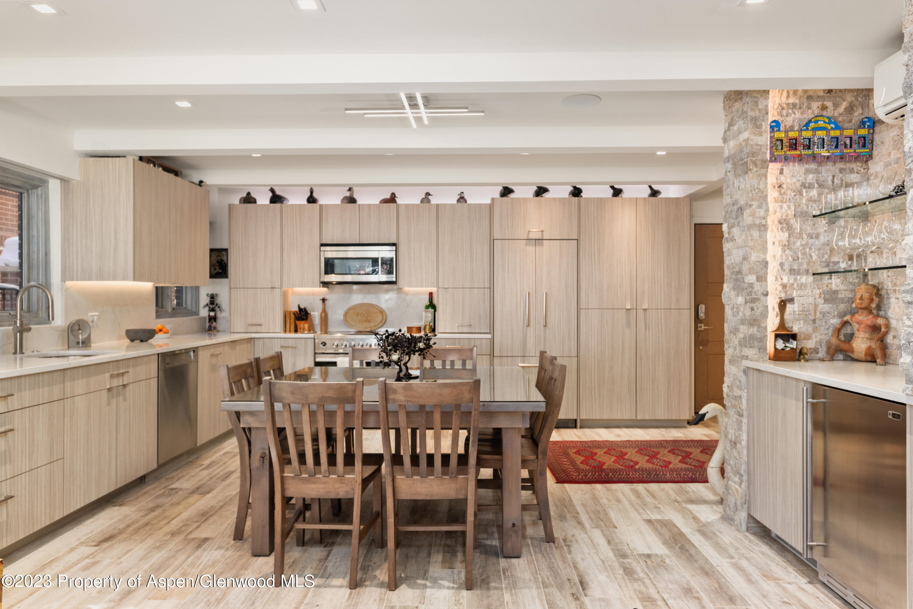 525 South Original Street, Unit B Aspen, CO 81611 - Photo 5 of 17 a view of a dining room with furniture and chandelier