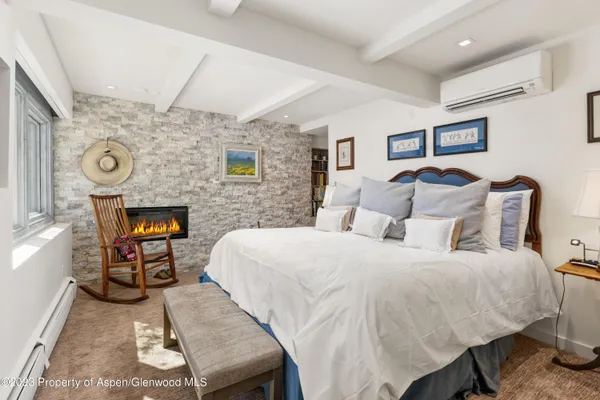 a bed room with a bed and a chair