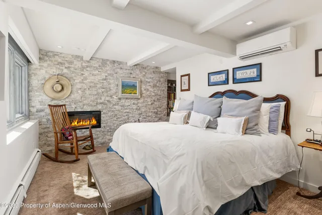 a bed room with a bed and a chair