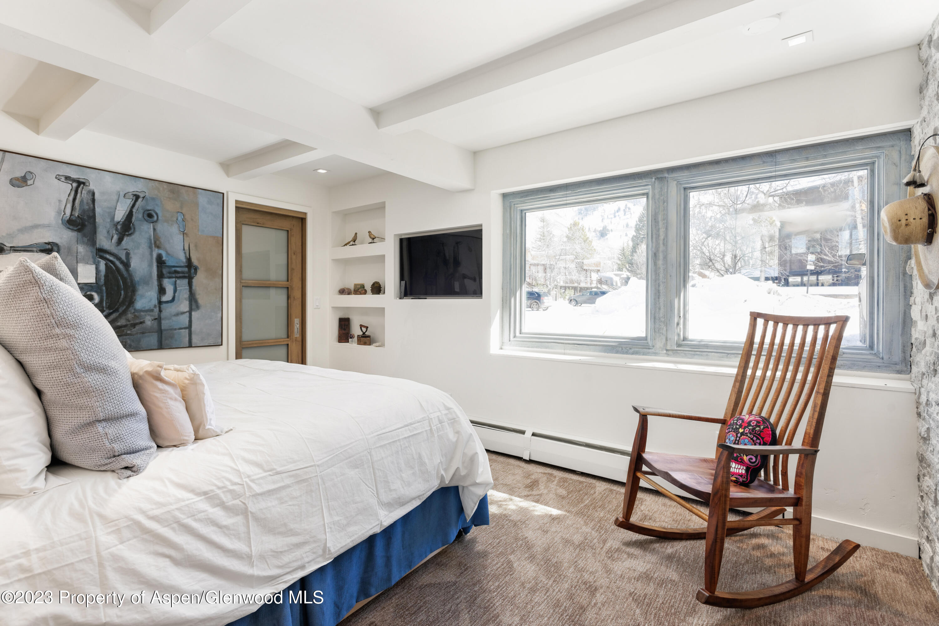 525 South Original Street, Unit B Aspen, CO 81611 - Photo 9 of 17 a bedroom with a bed a chair and a large window