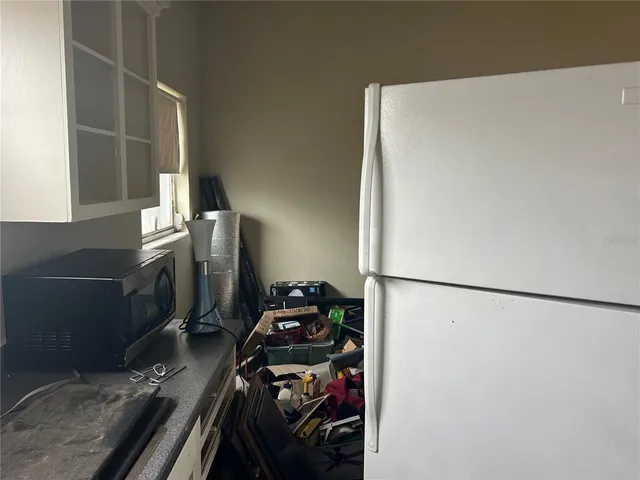 a kitchen with a refrigerator and a stove