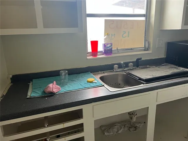 a bathroom with a sink and a window