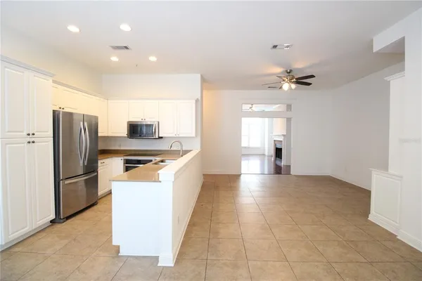 a kitchen with stainless steel appliances a refrigerator and a stove top oven