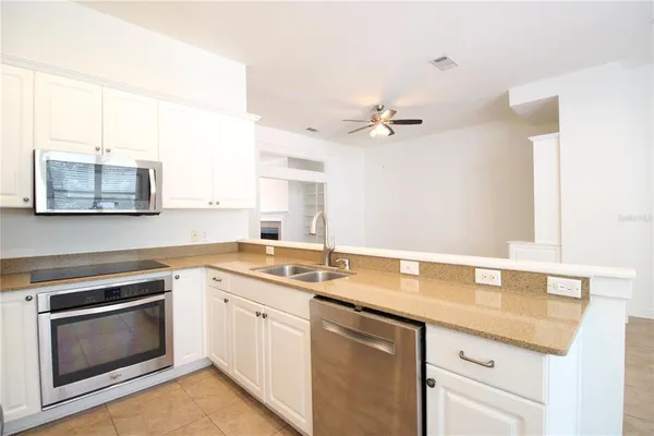 a kitchen with a sink stove and microwave