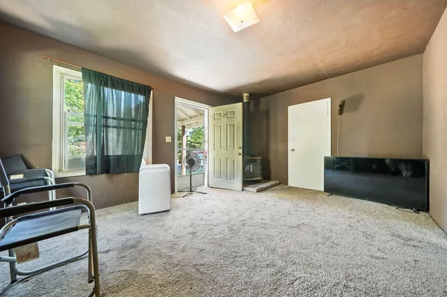 a view of a livingroom with furniture and floor to ceiling window
