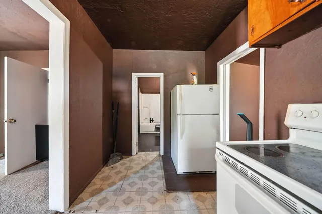 a view of a kitchen with a refrigerator and a stove