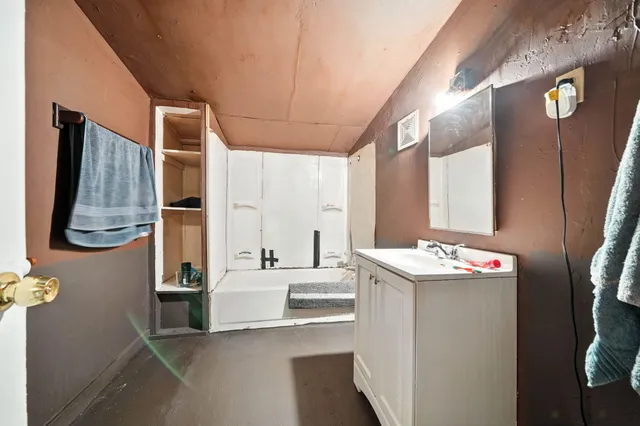 a bathroom with a sink vanity and mirror