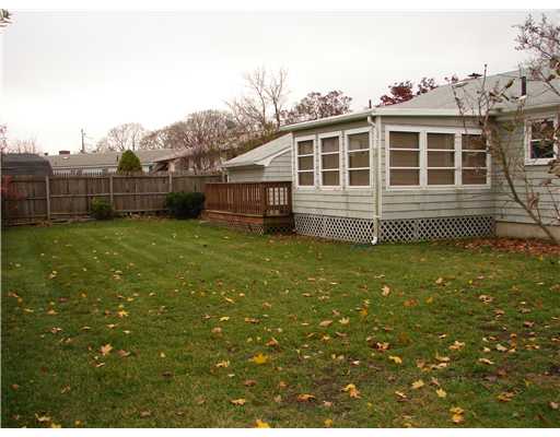 20 Newell Road Cranston, RI 02910 - Photo 2 of 20 Exterior Back. Great back yard! This is also a view of the homes four season room and out side deck. There are sliders off the formal dining room that open into the four season room. There is also a door off the four season room that opens to the large deck.