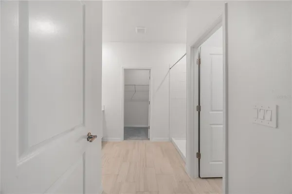 a white toilet sitting next to a shower