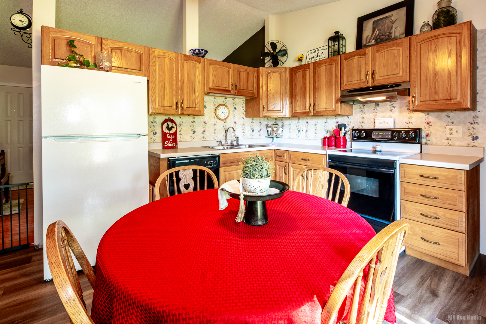 827 Independence Drive Bourbonnais, IL 60914 - Photo 9 of 25 a kitchen with a refrigerator a stove a sink dishwasher and a dining table with wooden cabinet