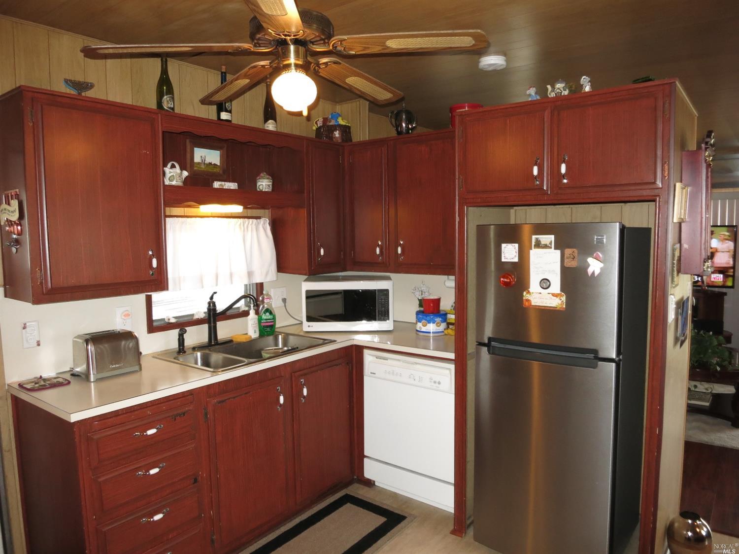 480 El Capitan Way, Unit 480 Santa Rosa, CA 95407 - Photo 1 of 1 a kitchen with wooden cabinets and refrigerator