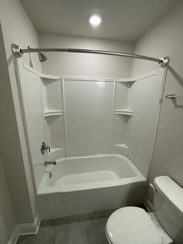 a bathroom with a toilet and a bathtub