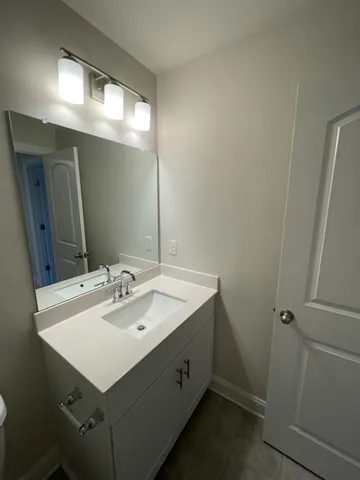 a bathroom with a sink a mirror and a vanity
