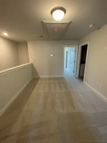 an empty room with a empty space and windows