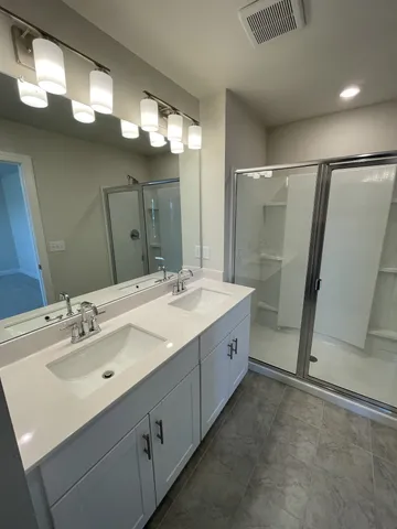 a bathroom with a double vanity sink mirror and double