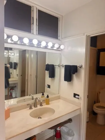 a bathroom with a shower and a mirror