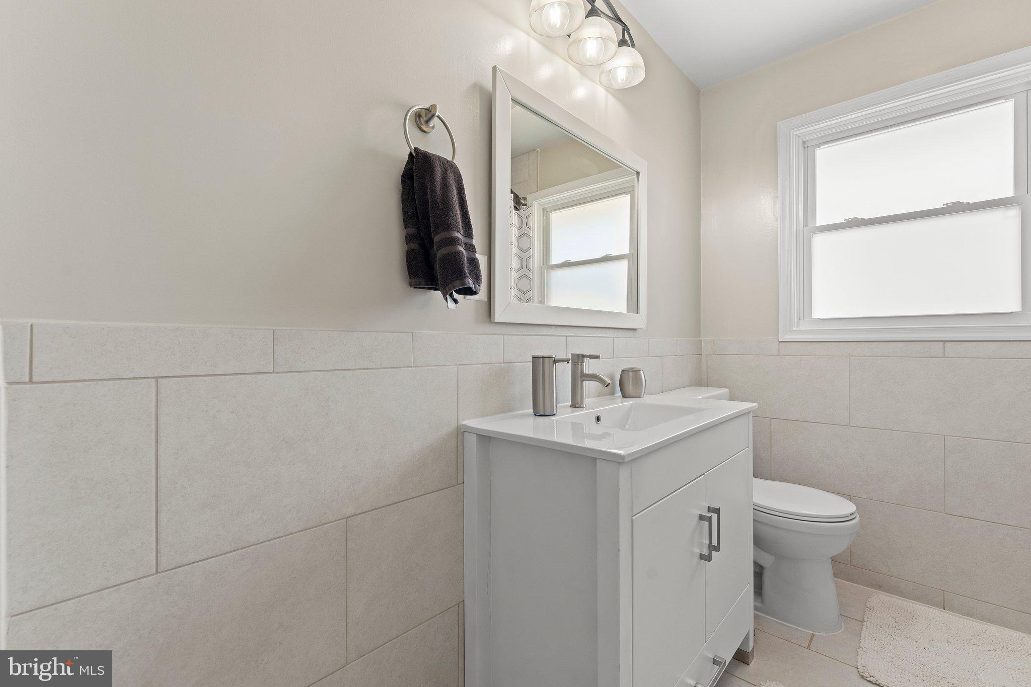 6408 Zekan Lane Springfield, VA 22150 - Photo 24 of 72 a bathroom with a toilet sink and mirror