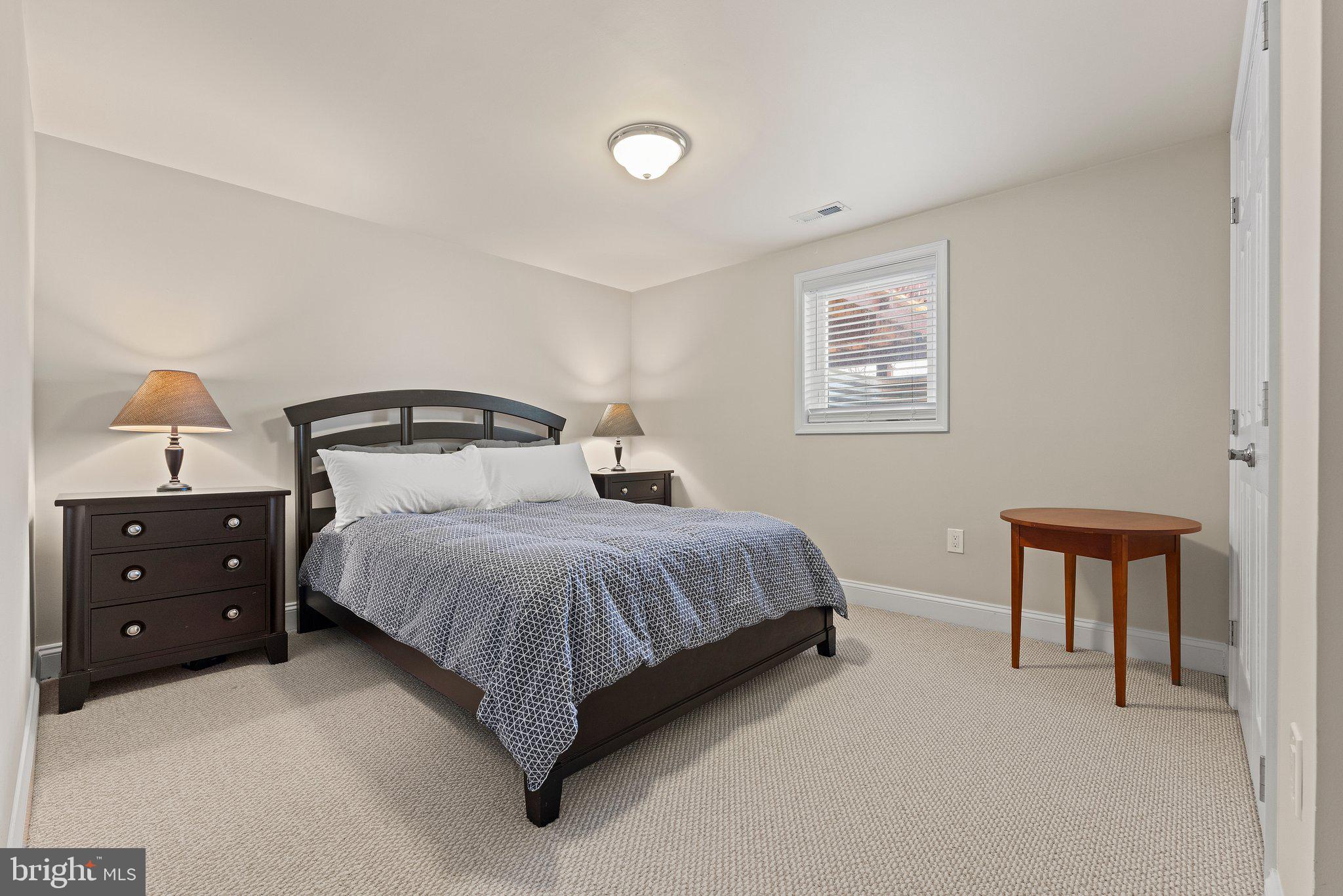 6408 Zekan Lane Springfield, VA 22150 - Photo 43 of 72 a bedroom with a bed and a night stand