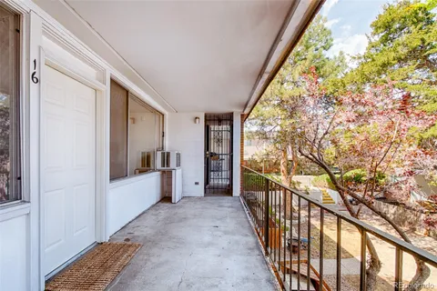 a view of hallway with wooden floor and windows