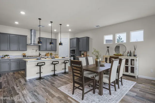 a kitchen with kitchen island granite countertop a table and chairs in it