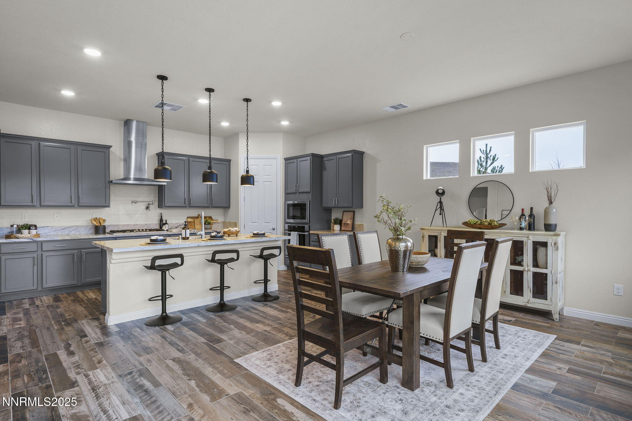 8326 Simsbury Drive Reno, NV 89439 - Photo 12 of 33 a kitchen with kitchen island granite countertop a table and chairs in it