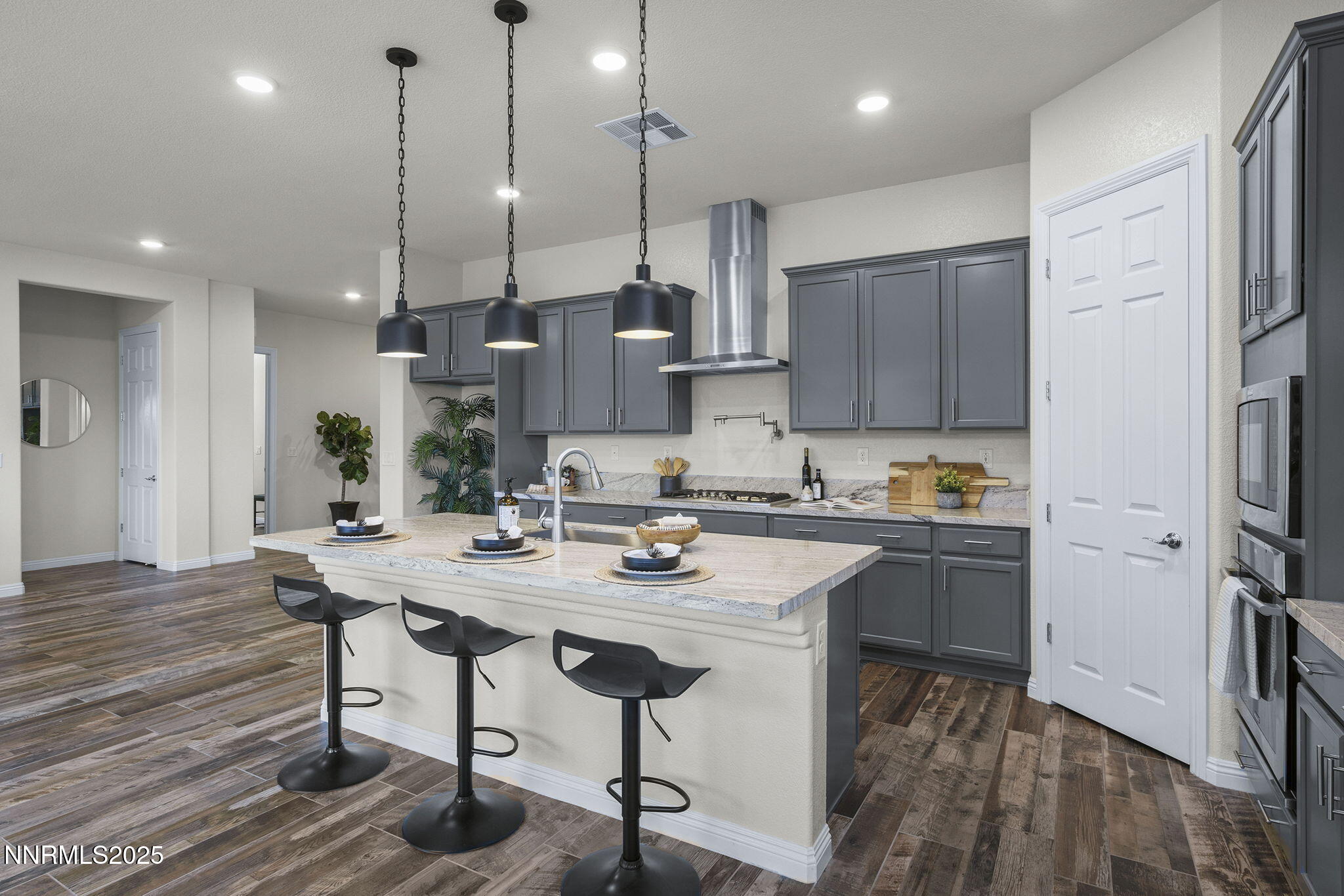 8326 Simsbury Drive Reno, NV 89439 - Photo 14 of 33 a kitchen with stainless steel appliances granite countertop a sink a stove a refrigerator and island with wooden floor