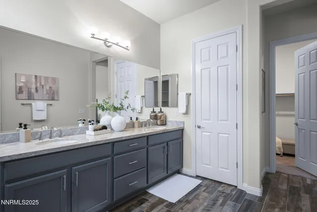 a bathroom with a double vanity sink and a mirror