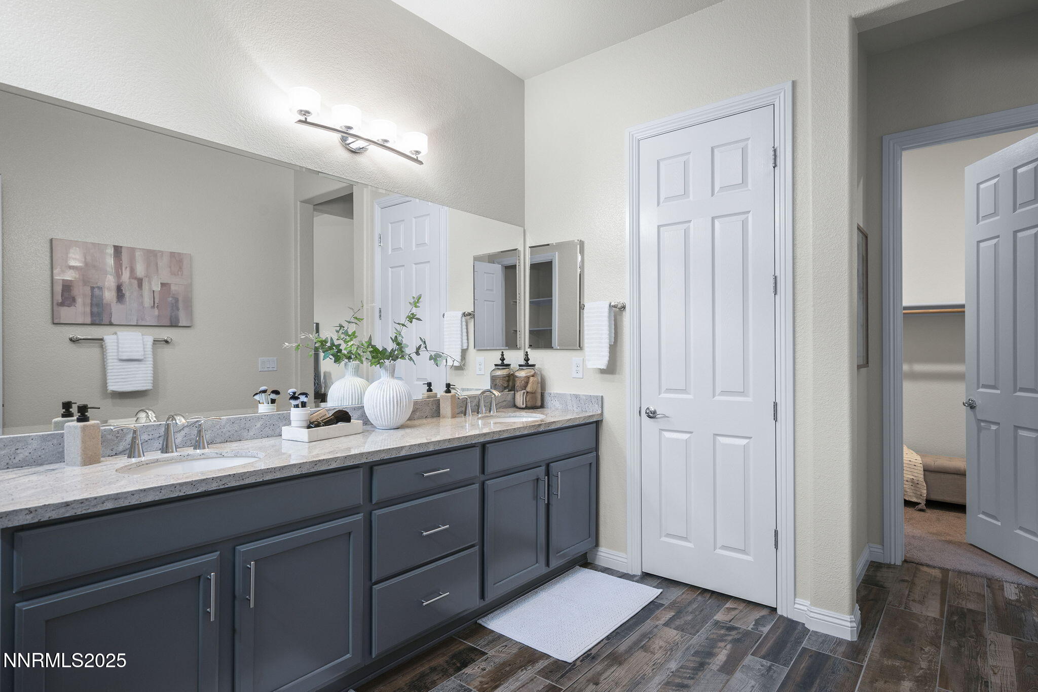 8326 Simsbury Drive Reno, NV 89439 - Photo 17 of 33 a bathroom with a double vanity sink and a mirror