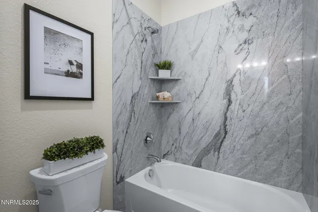 a kitchen with stainless steel appliances a sink a stove cabinets and wooden floor