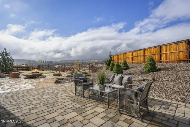 a view of a chairs and table in backyard