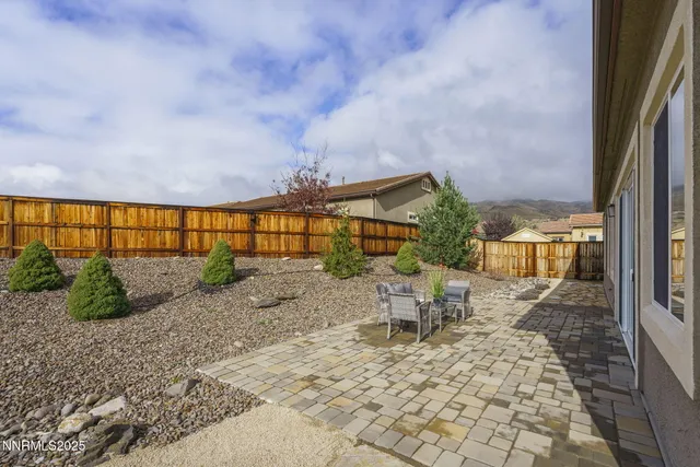 a view of a swimming pool with outdoor seating and city view