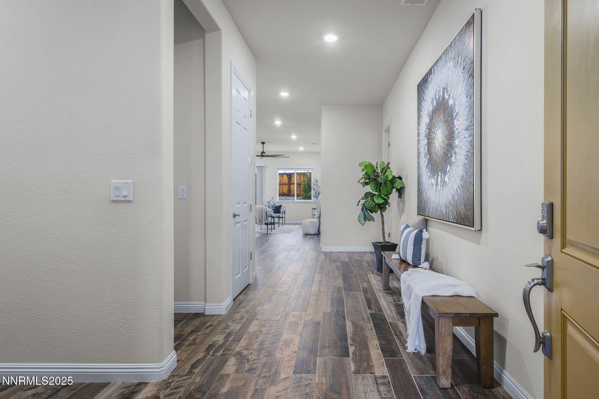8326 Simsbury Drive Reno, NV 89439 - Photo 4 of 33 a view of a hallway with wooden floor and furniture