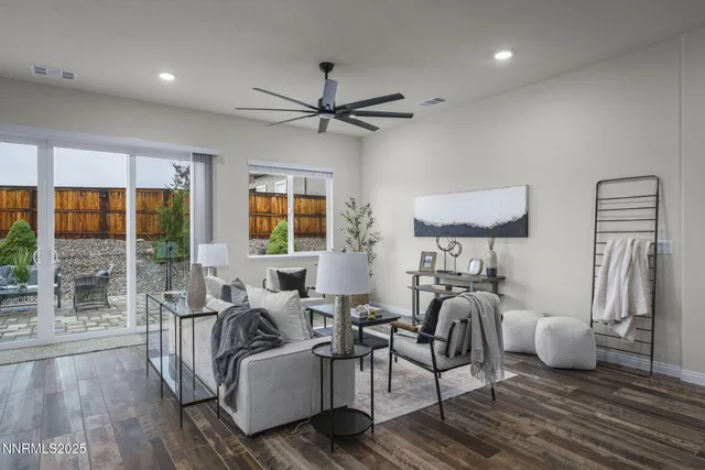 a living room with furniture a flat screen tv and a floor to ceiling window
