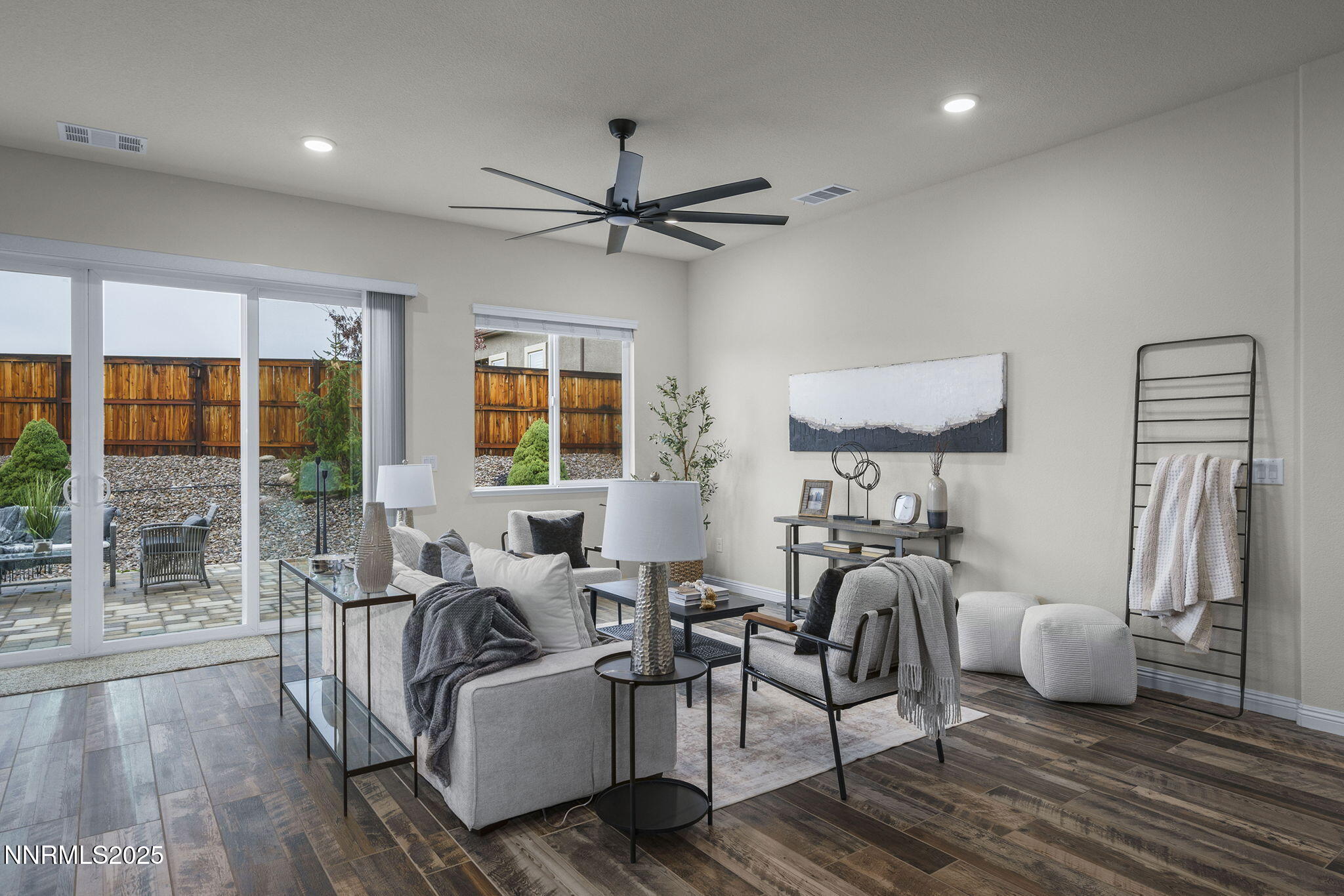 8326 Simsbury Drive Reno, NV 89439 - Photo 8 of 33 a living room with furniture a flat screen tv and a floor to ceiling window