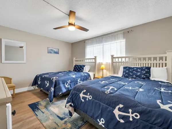 a bedroom with a large bed and a chandelier
