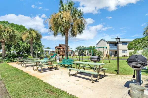 a view of a park with swings and slides