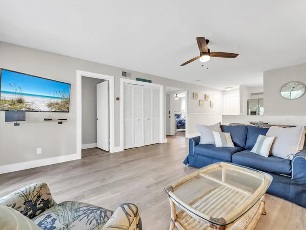 a living room with furniture and wooden floor