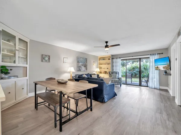 a view of a livingroom with furniture window and wooden floor