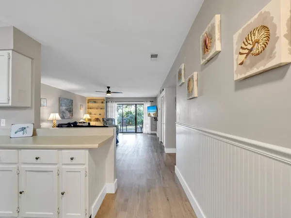 a kitchen with white cabinets appliances and sink