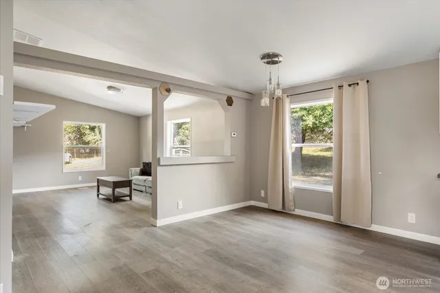 a view of a livingroom with furniture window and wooden floor