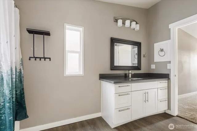 a bathroom with a granite countertop sink a mirror and a vanity