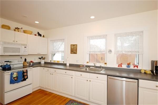 17 Cotter Road, Unit 17 Newton, MA 02468 - Photo 7 of 18 a kitchen with granite countertop a sink and cabinets
