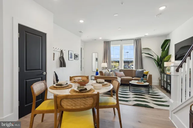 a living room with fireplace furniture and a potted plant