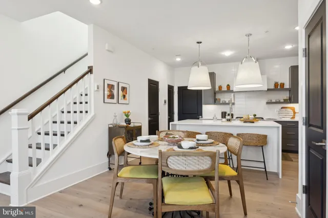 a dining room with furniture a rug and wooden floor
